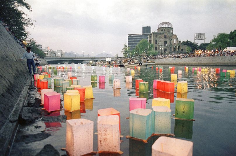 Le Dôme de la bombe atomique est visible au-dessus de lanternes en papier colorées flottant sur la rivière Motoyasu à Hiroshima, août 1988.