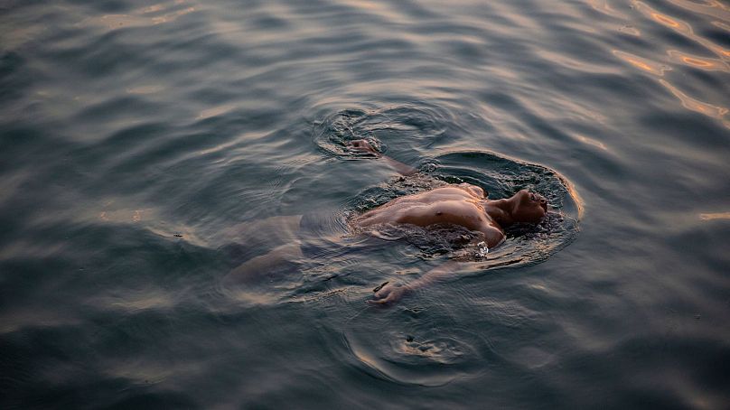 Un homme nage dans le lac Houhai pour combattre la chaleur étouffante de l'été à Pékin.  Il est pratiquement certain que 2023 sera l’année la plus chaude de l’histoire de l’humanité.