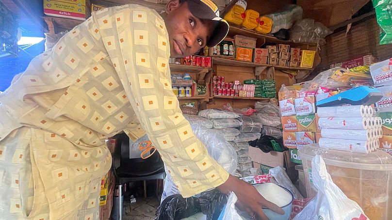 Abba Usman vend du sucre cristallisé dans son magasin d'un marché à Abuja, Nigeria, le 27 octobre 2023.