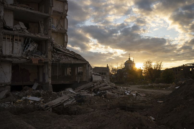 Le soleil se couche sur un bâtiment détruit à Izyum, en Ukraine, le mardi 24 octobre 2023.