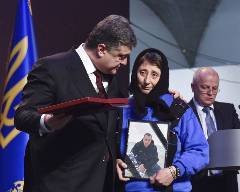 Le président ukrainien Porochenko remet le prix du Héros de l'Ukraine à un proche d'un militant tué lors des manifestations de masse lors d'une cérémonie à Kiev, le 20 février 2015.