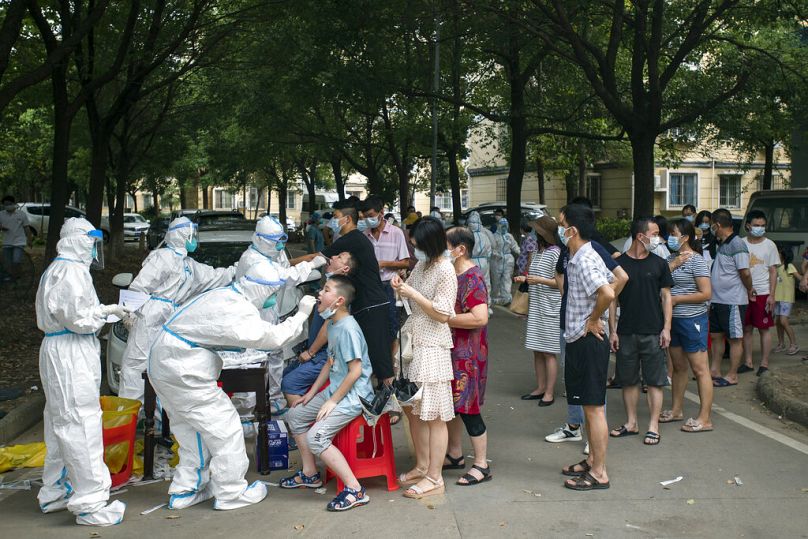 Des habitants font la queue pour être testés pour le COVID-19 à Wuhan, août 2021