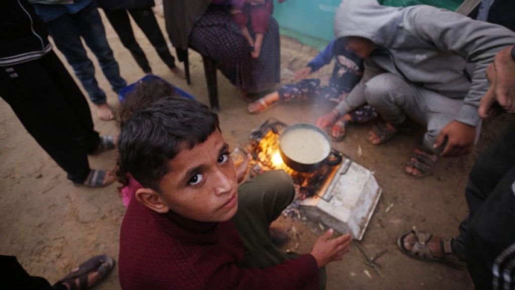 Palestinians struggle with cold weather as they stay in the makeshift tents they set up near Al Aqsa Martyrs Hospital in Deir al Balah, Gaza