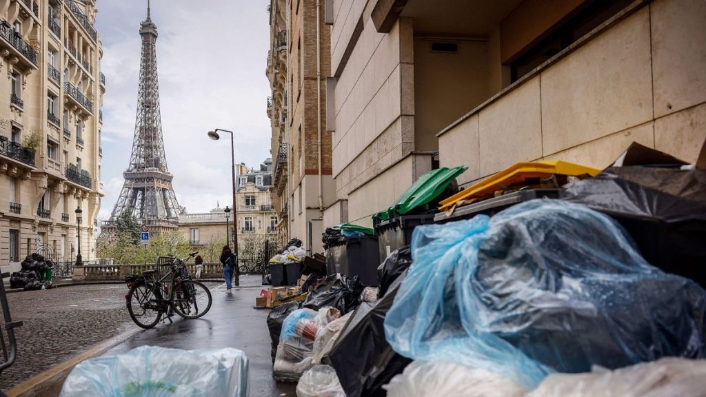 Uncollected rubbish piles up on a street near the Eiffel Tower in Paris, 24 March 2023.