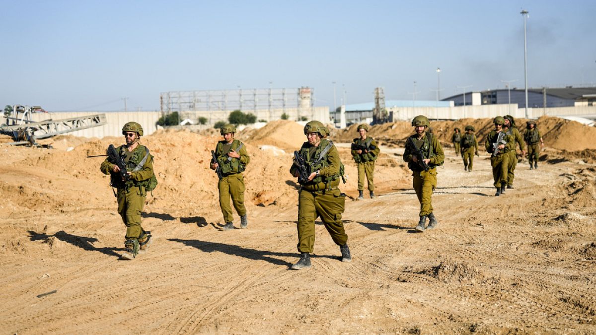 Israeli soldiers are seen during a ground operation in the northern Gaza Strip, amid a report of HRW reporting starvation being used as a tactic against Palestinians