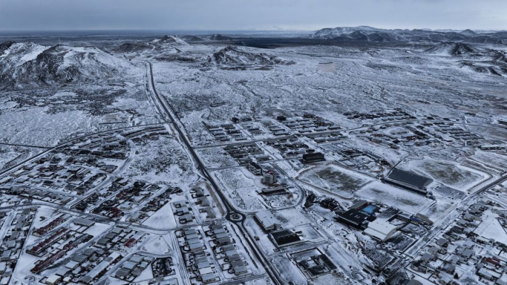 The lava field produced by the recent volcanic activity can be seen in the top background above Grindavik on Iceland