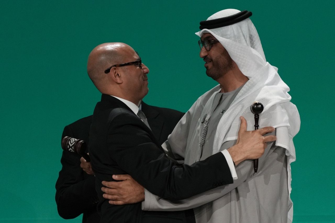 Le chef du climat des Nations Unies, Simon Stiell, embrasse le président de la COP28, Sultan al-Jaber, à droite, après le dernier coup de marteau.