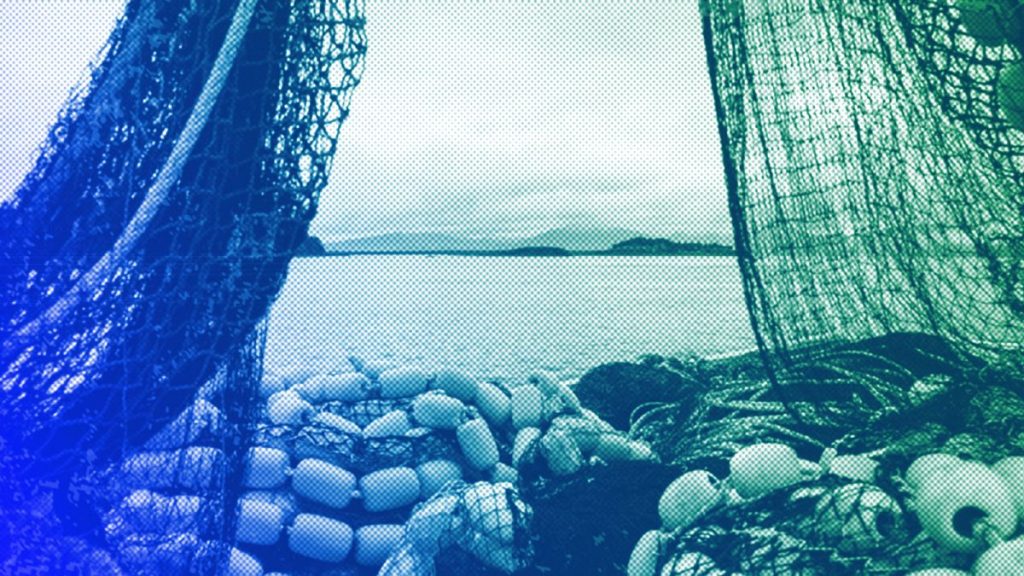 Fishing nets sit stacked on the deck of a fishing boat in Kodiak, AK, June 2023