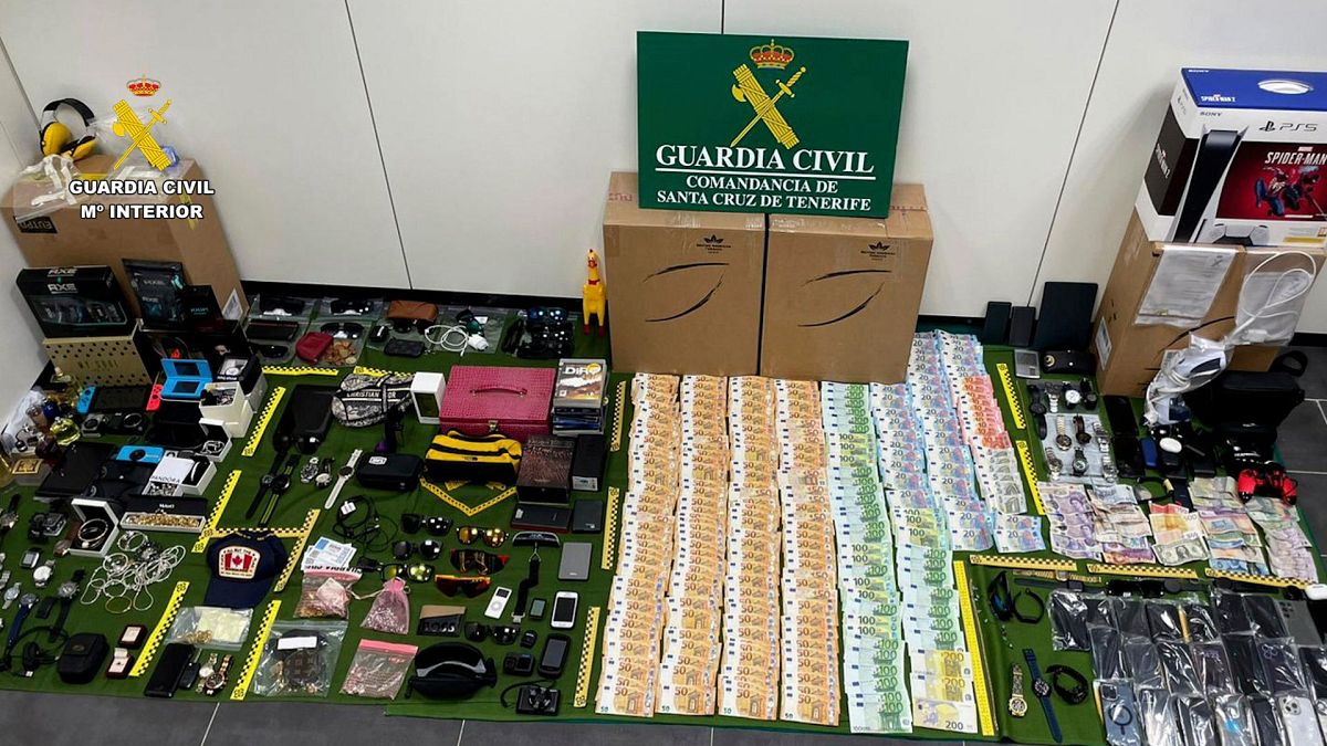 In this photo provided by the Guardia Civil on Friday 15 December 2023, items stolen from suitcases are displayed on the Canary island of Tenerife, Spain.