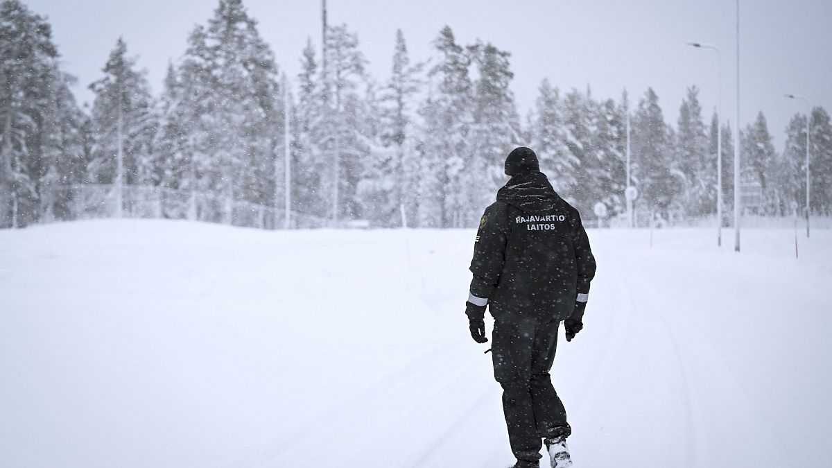 A Finnish Border Guard walks in the snow at the Raja-Jooseppi international border crossing station between Russia and Finland, in Inari, northern Finland, Saturday, Nov. 25,