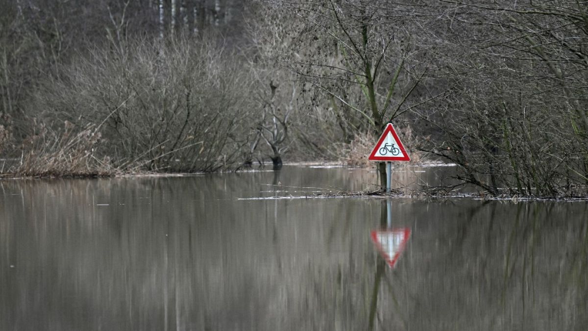 A photo taken on December 27, 2023 shows a traffic sign at the flooded Lippe river in Hamm, western Germany.