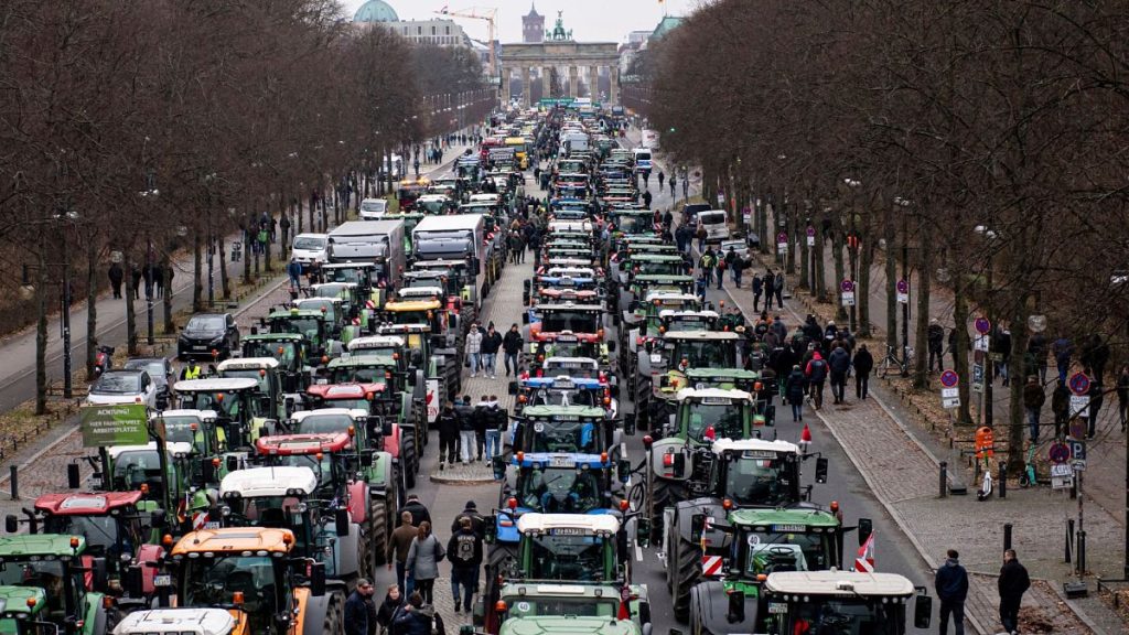 Farmers with tractors take part in a protest rally organized by the German Farmers