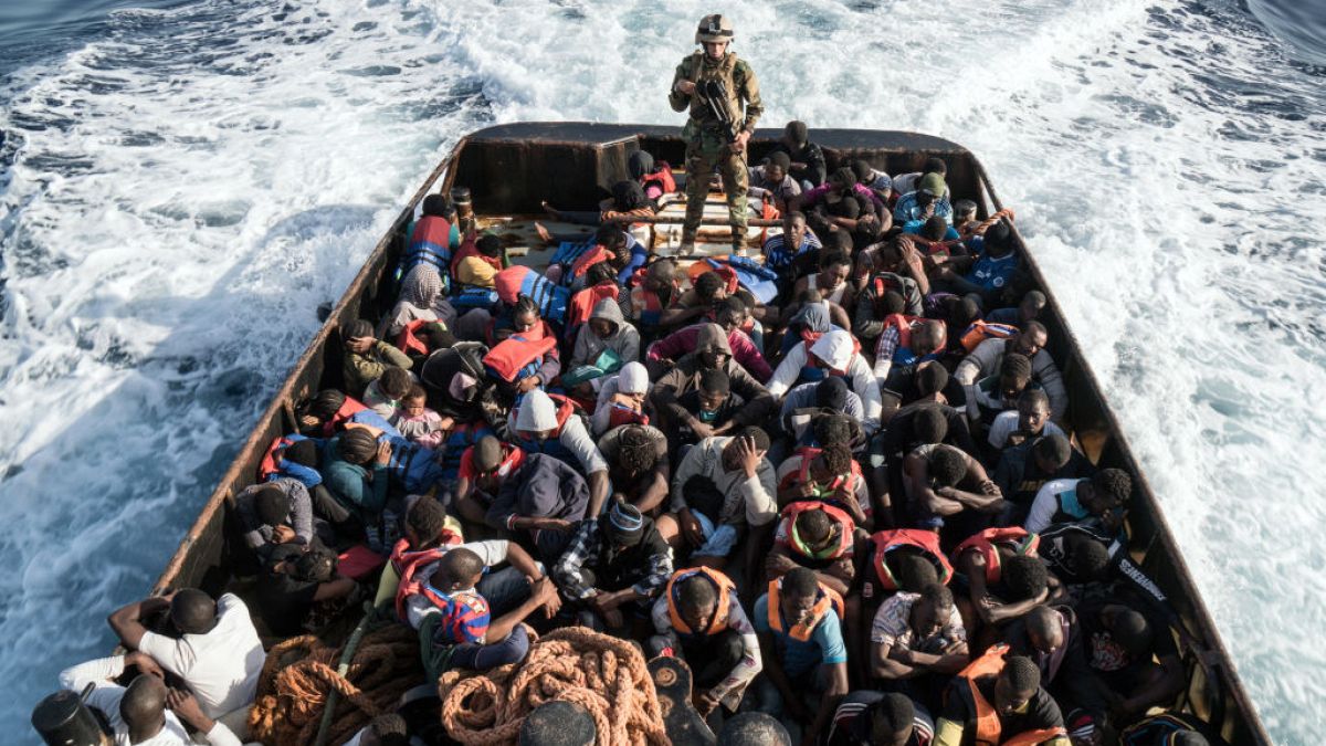 Long term issue: A Libyan coast guardsman stands on a boat during the rescue of 147 illegal immigrants attempting to reach Europe in 2017