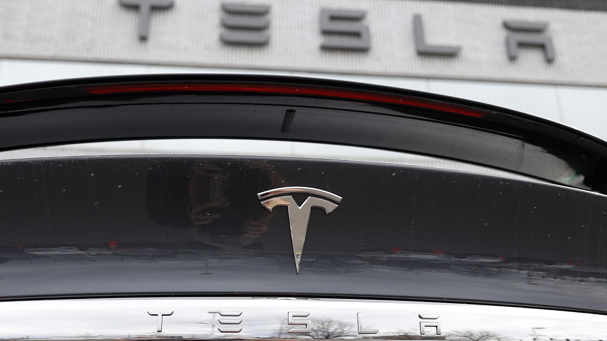 FILE - The Tesla company logo shines off the rear deck of an unsold 2020 Model X at a Tesla dealership, April 26, 2020, in Littleton, Colo.