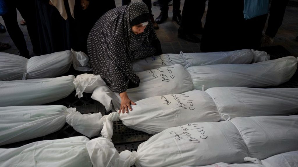 Palestinians mourn their relatives killed in the Israeli bombardment of the Gaza Strip, outside a morgue in Rafah, southern Gaza, Wednesday, Jan. 10, 2024.