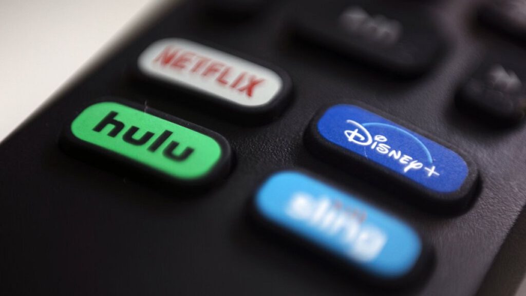 FILE - The logos for streaming services Netflix, Hulu, Disney Plus and Sling TV are pictured on a remote control on Aug. 13, 2020, in Portland, Ore.