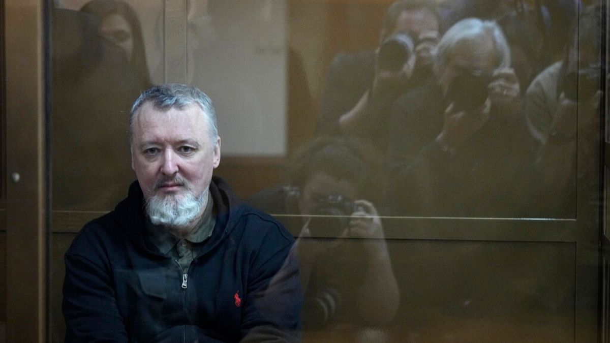Igor Girkin sits in a glass cage in a courtroom at Moscow