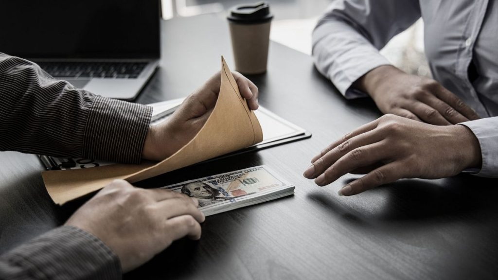 Stock image of bribe being paid