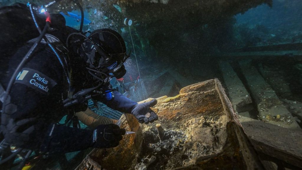 Parks Canada underwater archaeologist Marc-André Bernier carefully excavates a seamen’s chest on the lower deck of HMS Erebus, 14 September, 2023.