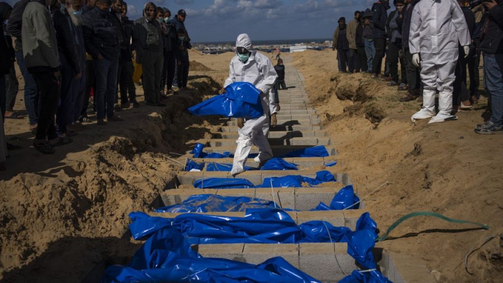 Palestinians bury the bodies of people who were killed in fighting with Israel and returned to Gaza by the Israeli military, during a mass funeral in Rafah, Gaza Strip.