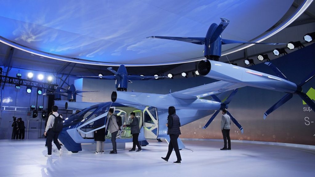 People look at the Supernal S-A2 passenger electric VOTL aircraft at the Supernal booth during the CES tech show Wednesday, January 10, 2024, in Las Vegas.