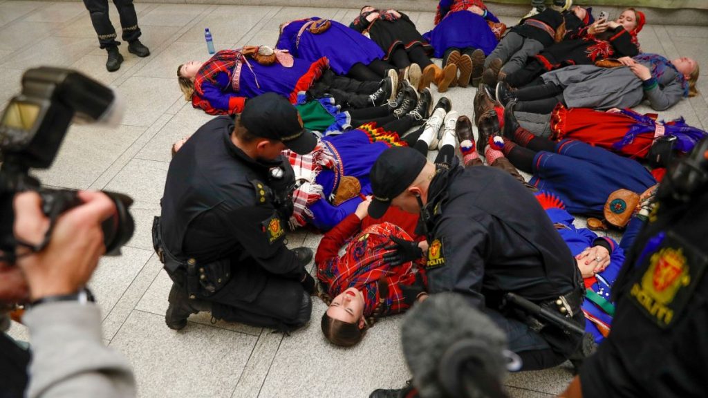 FILE - Demonstrators take part in a lie-in at the Norwegian Parliament in Oslo, Wednesday, Oct. 11 2023.