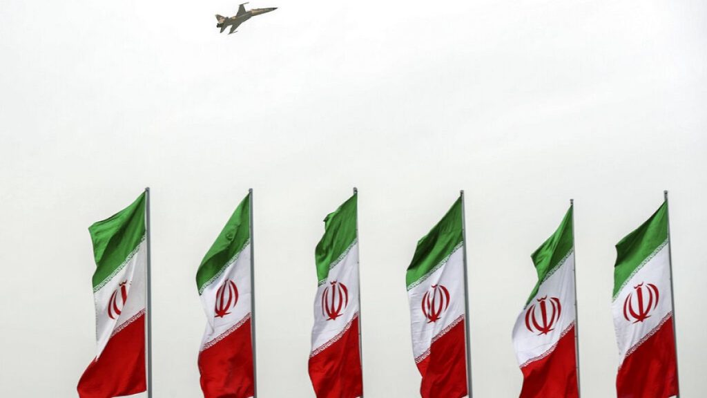 A fighter jet flies over Iranian flags during the army parade in Tehran