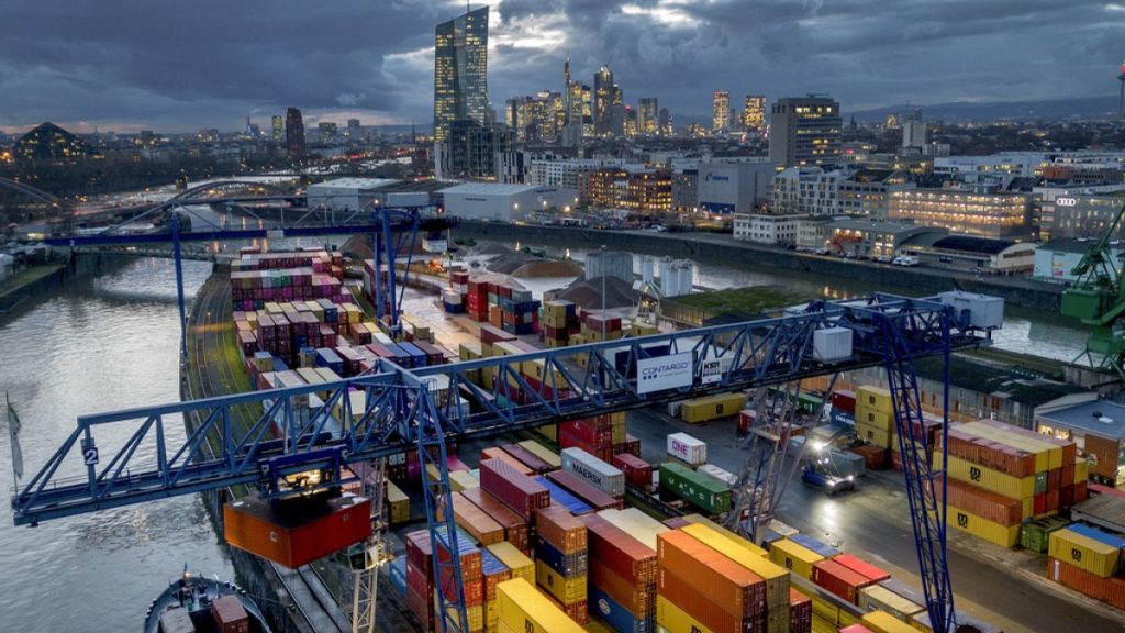 A container is loaded onto a cargo ship in the harbor in Frankfurt, Germany, Wednesday, Dec. 13, 2023.