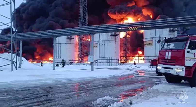 Des employés du ministère russe des Urgences travaillent aux côtés des incendies de réservoirs de pétrole après que le drone a atteint Klintsy, une ville de la région de Briansk en Russie.