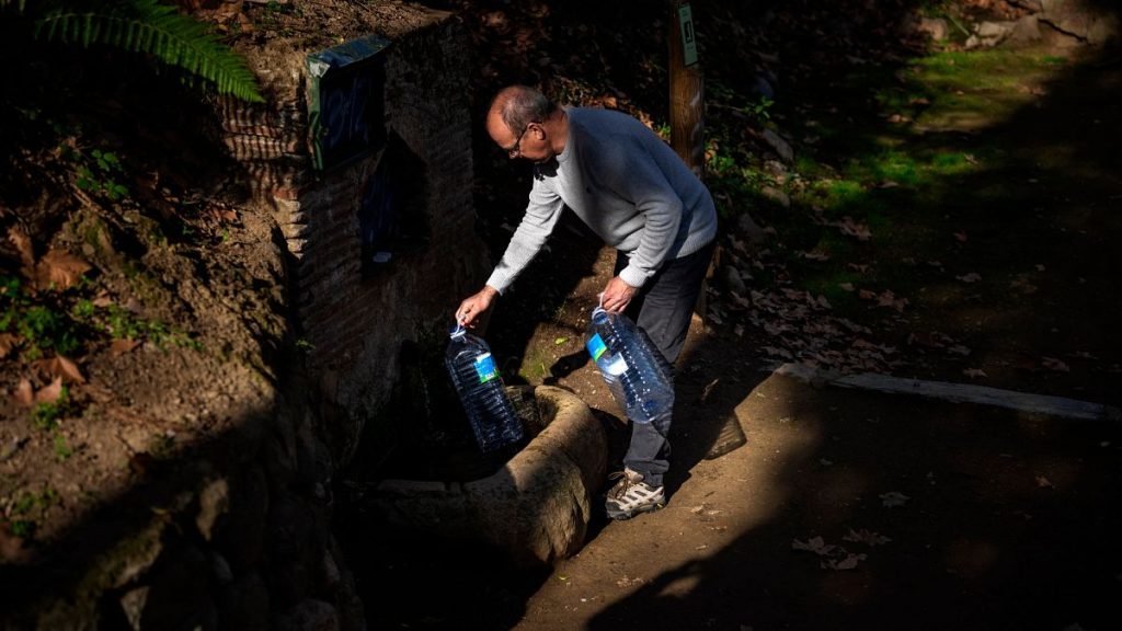 Joan Torrent, 64, fills plastic jugs at a natural spring in Gualba.