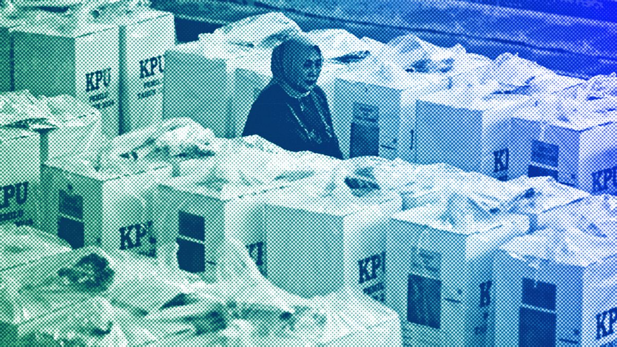 An electoral worker inspects ballot boxes prepared to be distributed to polling stations, ahead of the Feb. 14 election, at a stadium in Jakarta, February 2024