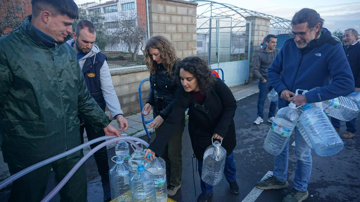 África Villén, centre, queues with other residents to collect drinking water from a tanker in Pozoblanco, 11 February 2024.