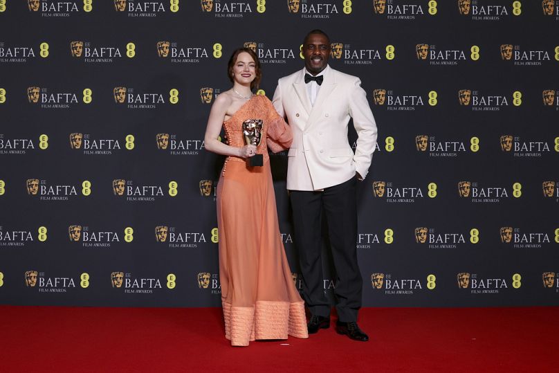 Emma Stone et Idris Elba posent pour les photographes lors de la 77e cérémonie des British Academy Film Awards, les BAFTA, à Londres.