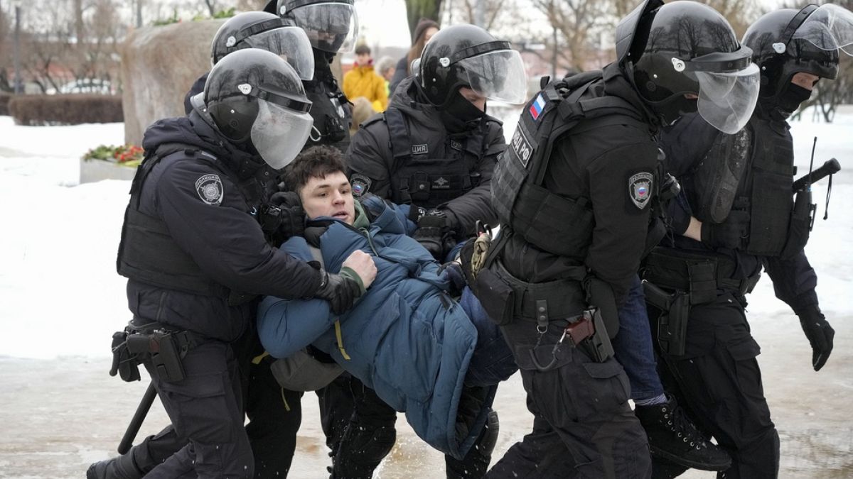 Police detain a man as he wanted to lay flowers paying their last respect to Alexei Navalny at the monument, a large boulder from the Solovetsky islands.