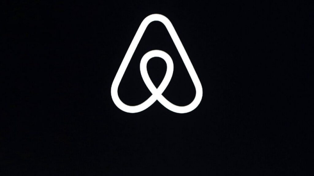 This Feb. 22, 2018, file photo shows an Airbnb logo during an event in San Francisco.