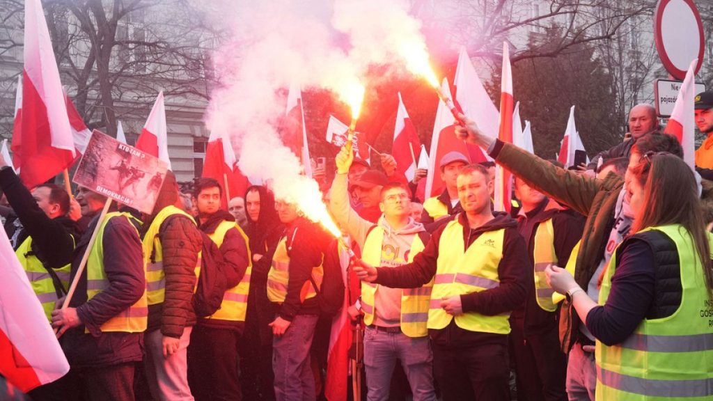 Polish farmers with national flags and angry slogans written on boards protest against European Union green policies that trim their production and against cheap grain.