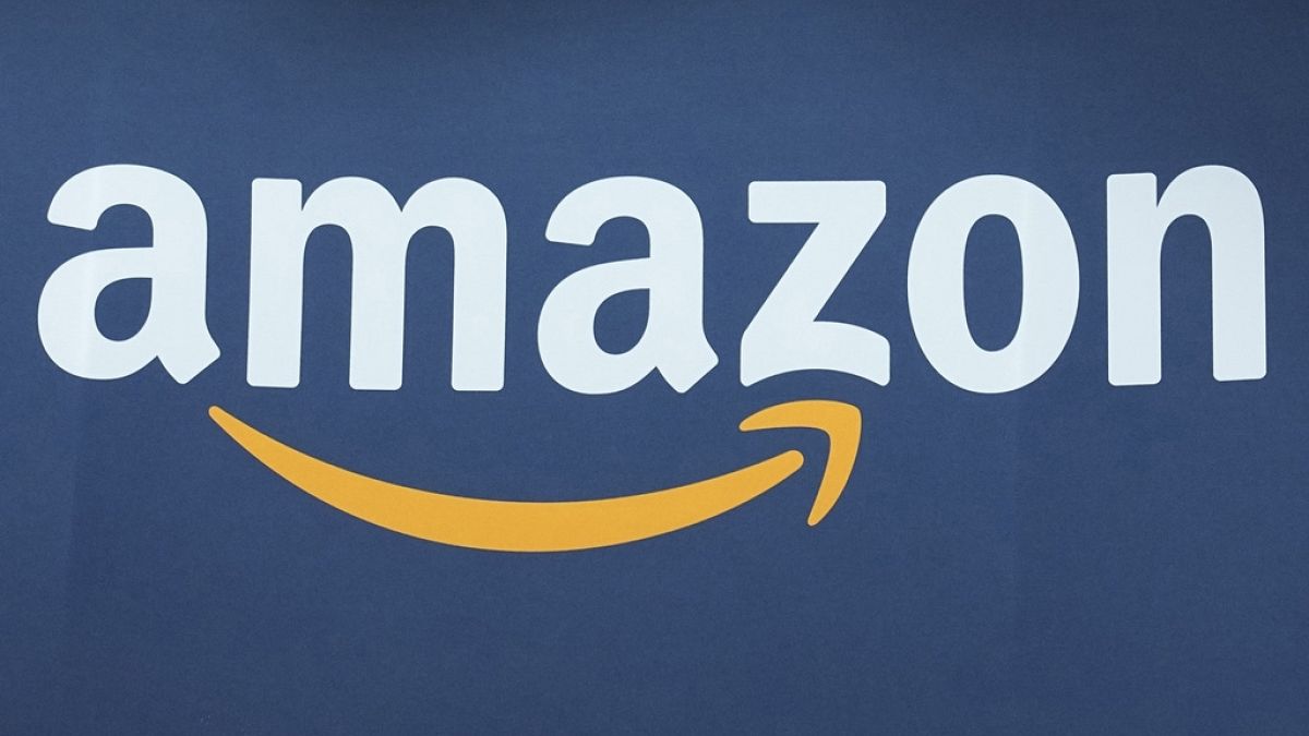 he Amazon logo is seen, June 15, 2023, at the Vivatech show in Paris. Amazon.com is being added to the Dow Jones Industrial Average, joining Apple, Walt Disney, Walmart and ot