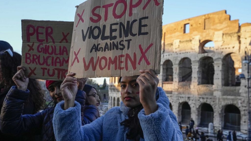 A woman holds a banner that reads