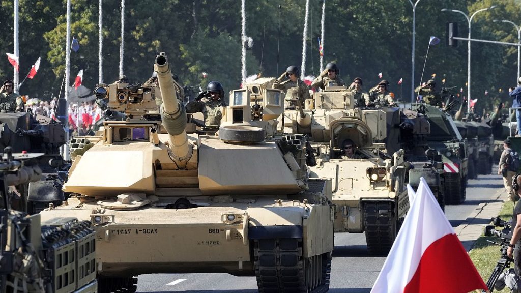 U.S.-made Abrams tanks purchased by Poland take part in a massive military parade to celebrate the Polish Army Day.