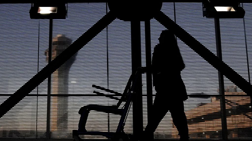 An airline employee transfers a wheelchair to her station at O