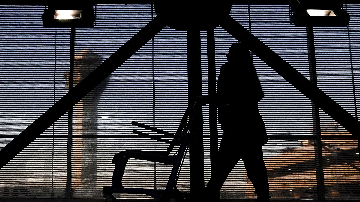 An airline employee transfers a wheelchair to her station at O