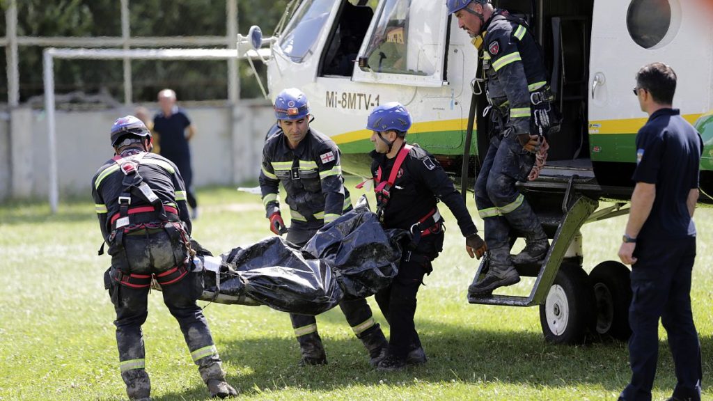 Rescue workers carry the body of a victim of landslide near Shovia, bout 140 kilometers (85 miles) northwest of the capital Tbilisi, Georgia, Friday, Aug. 4, 2023.