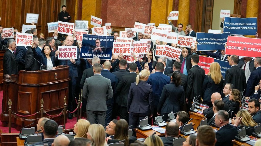 Opposition lawmakers hold banners reading: "Stole the elections" during a Serbia