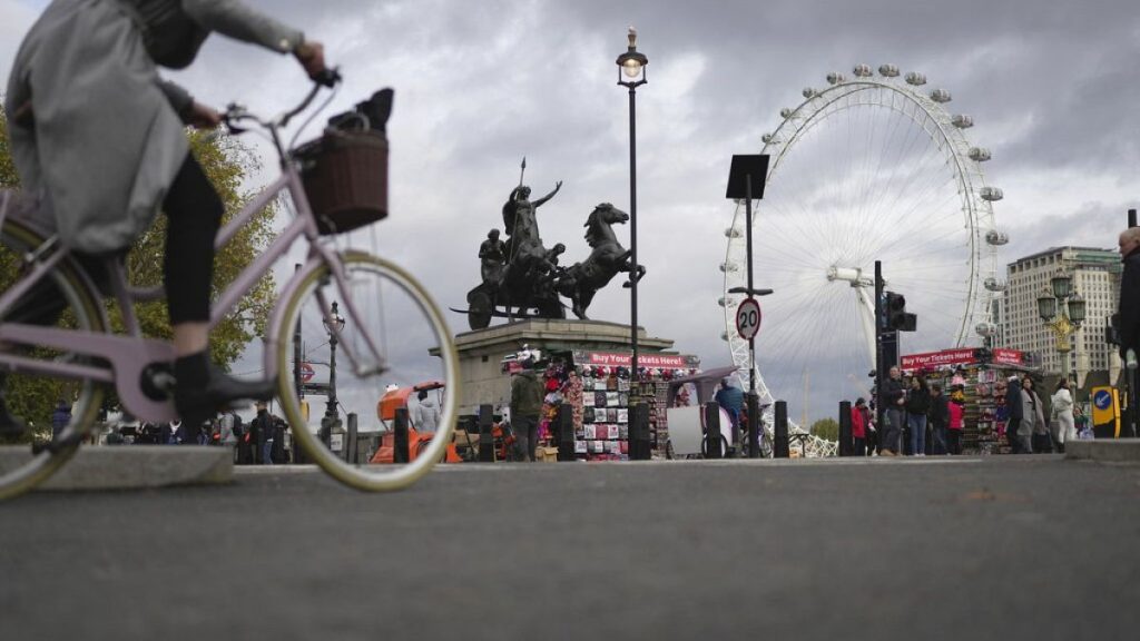 A woman rides a bike in London, Thursday, Nov. 17, 2022.