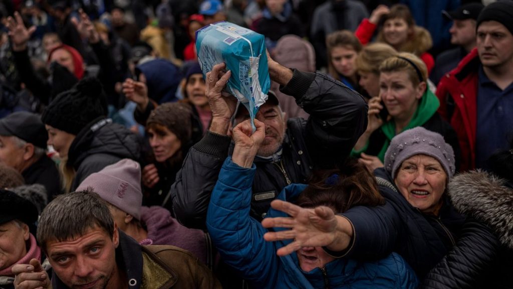 Residents gathering at an aid distribution point receive supplies in downtown Kherson, southern Ukraine.