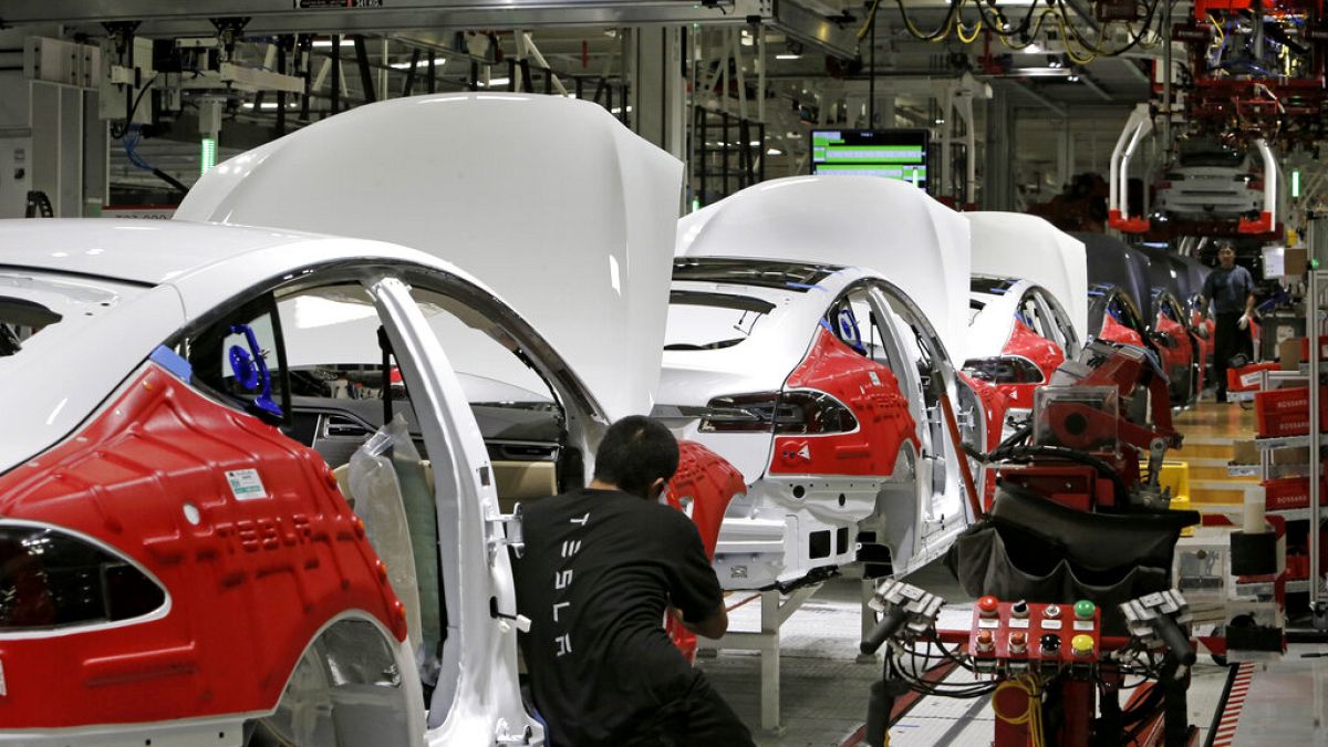 Cars move through the assembly line at Tesla Motors, California