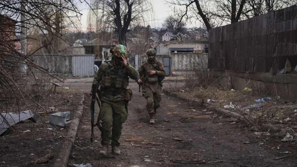 Ukrainian soldiers walk along a street in the area of the heaviest battles with the Russian invaders in Bakhmut, Donetsk region, Ukraine, Wednesday, 15 March, 2023.