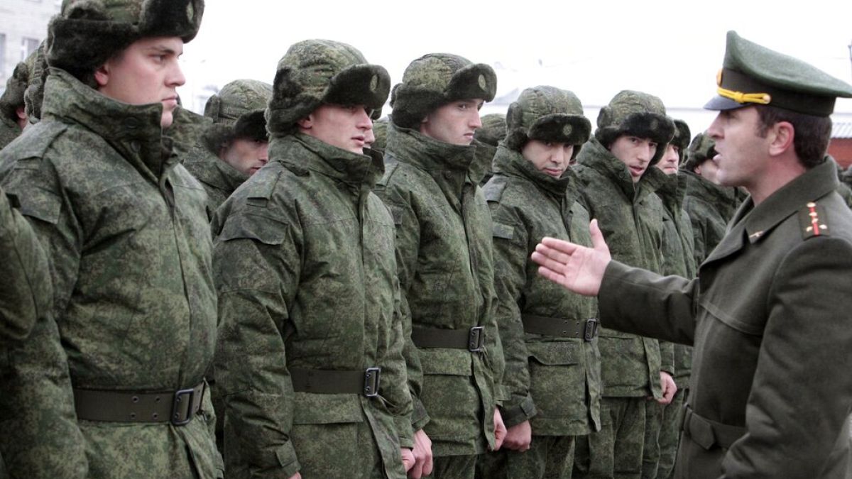 FILE- Conscripts stand at a military conscription office in Grozny, Chechnya