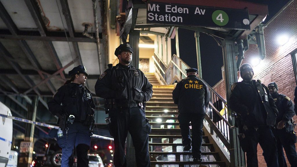 New York City Police officers stand guard following a shooting at the Mount Eden subway station, Monday, Feb. 12, 2024, in the Bronx borough of New York.