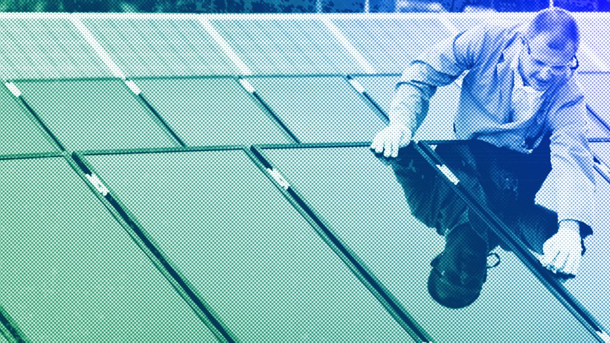 A man cleans rooftop solar panels in Berlin, 2007